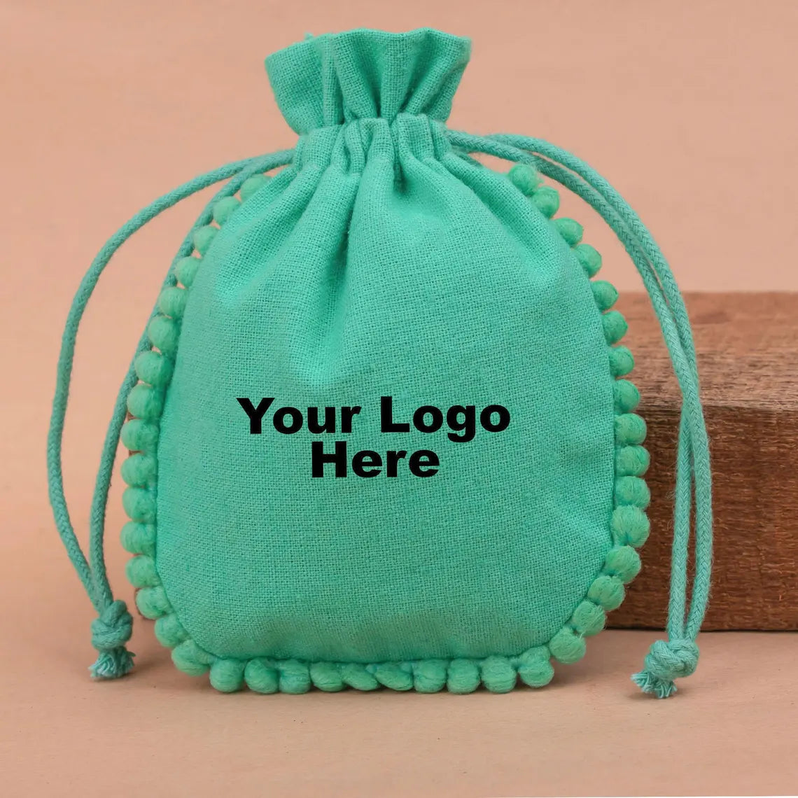 100 Vibrant Teal Designer Pouch: Accented with soft Pom Poms