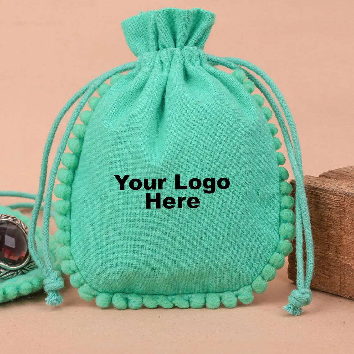 100 Vibrant Teal Designer Pouch: Accented with soft Pom Poms