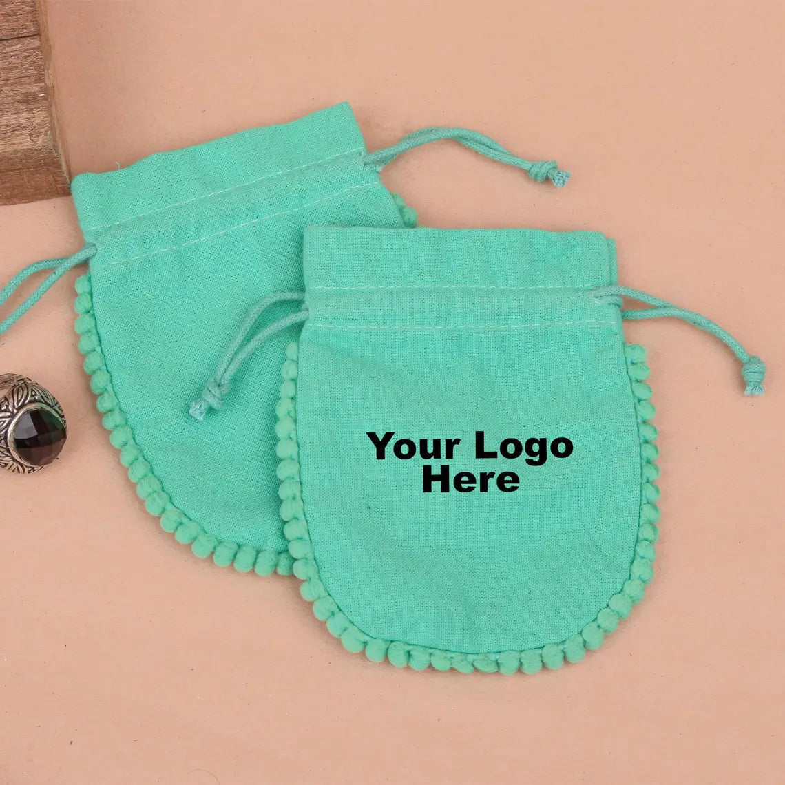 100 Vibrant Teal Designer Pouch: Accented with soft Pom Poms