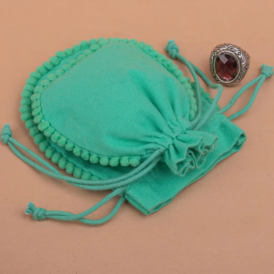 100 Vibrant Teal Designer Pouch: Accented with soft Pom Poms