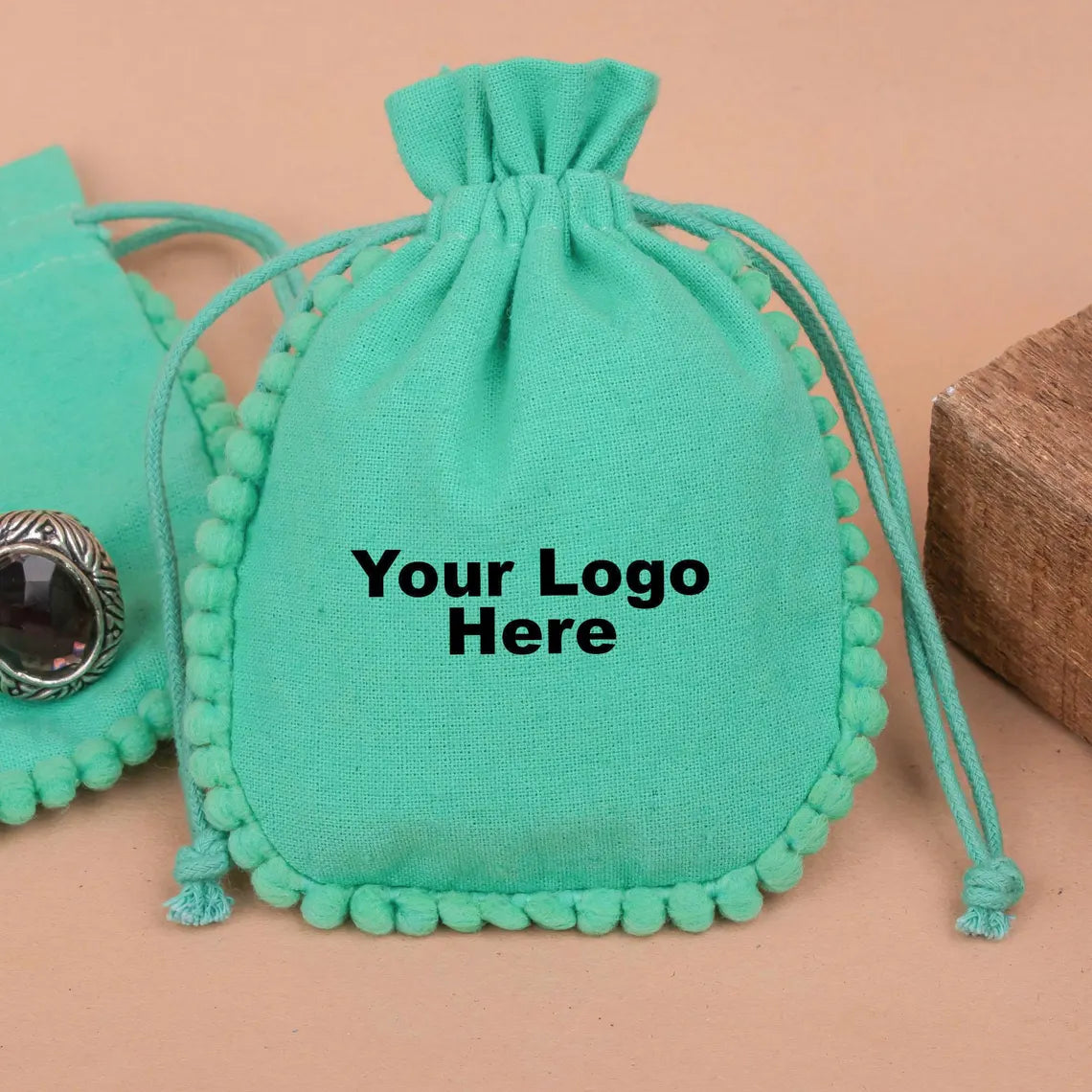 100 Vibrant Teal Designer Pouch: Accented with soft Pom Poms